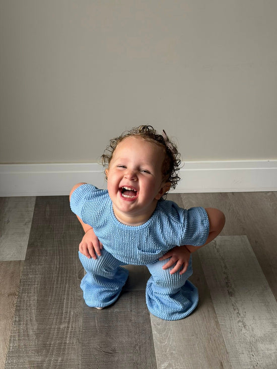 Toddler girl in light blue waffle flare pant and matching short sleeve waffle top